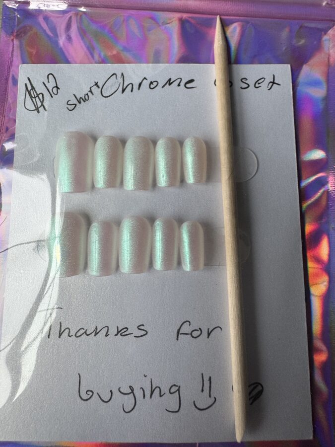 Short pearlescent chrome press-on nails with a green shimmer