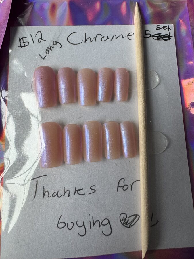 Long pearlescent chrome press-on nails with a pink and blue shimmer