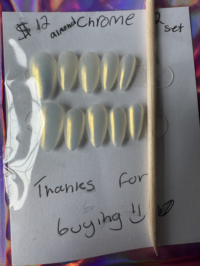 Almond-shaped pearlescent chrome press-on nails with a golden shimmer