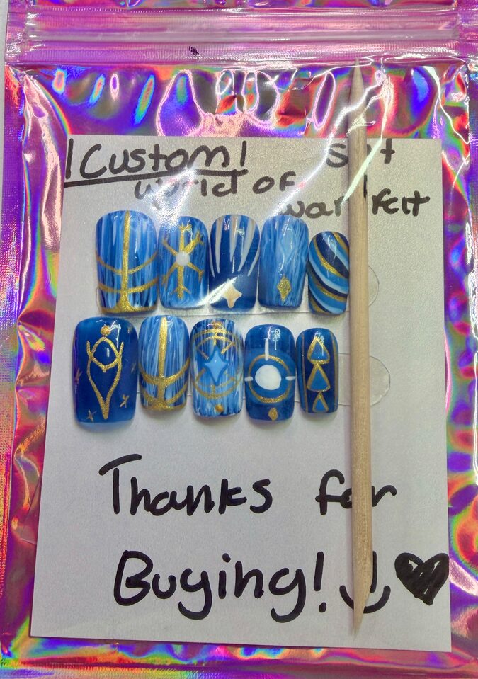 Blue World of Warcraft Night Elf Frost Mage press-on nails with gold and white designs, packaged in a holographic pouch